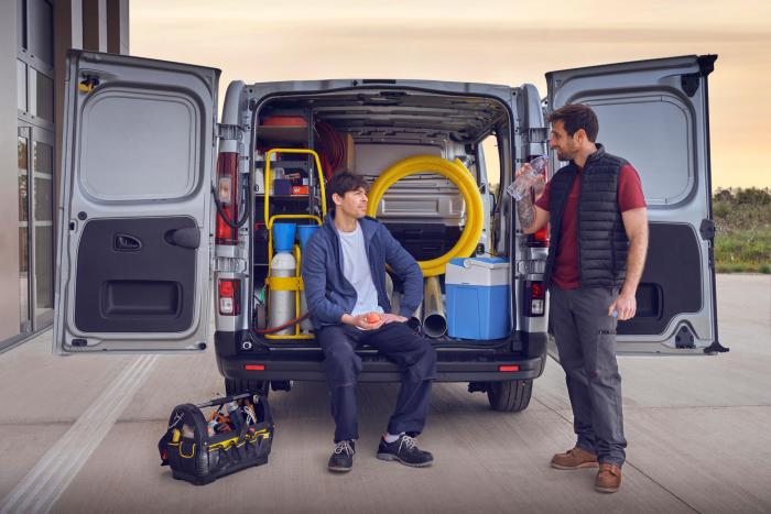 Craftsman chatting in the back of LCV containing tools